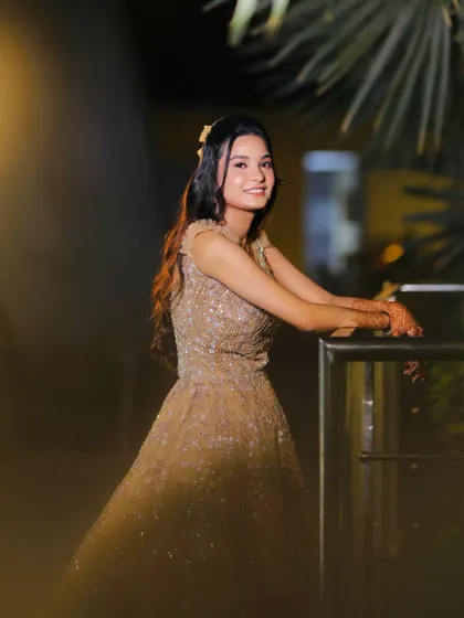 A candid shot of the engagement look. The half-up hairstyle with a simple accessory adds a touch of modern elegance.