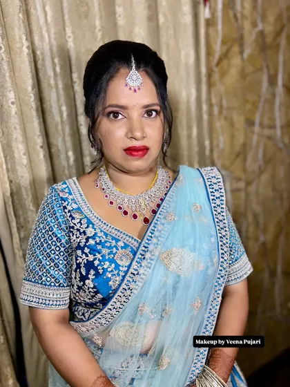A glamorous reception look featuring a beautiful blue lehenga. I paired it with soft pink eyeshadow, a bold red lip, and sparkling diamond jewelry for a truly show-stopping effect.