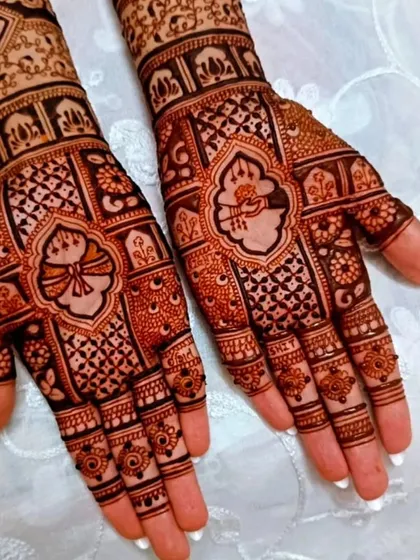 A close-up of the palms with a beautiful, symmetrical design. The use of negative space makes the central motifs stand out.