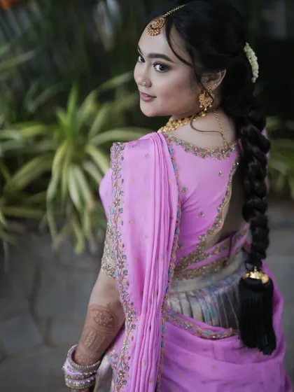 The back view of the pink and grey langa voni, showing the elegant hairstyle and blouse details.