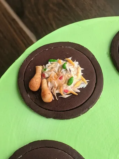 A miniature plate of chicken biryani, sculpted entirely from fondant. This was part of a set of toppers for a foodie-themed cake.