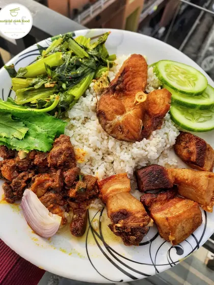 A perfect combination of textures and flavours. This plate has crispy fried pork, fried fish, liver and gizzard fry, and mustard leaves kangsoi.