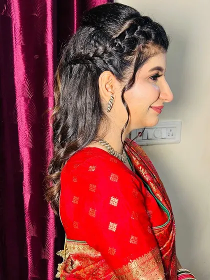A side profile of the bride, highlighting the beautiful hairstyle and makeup.