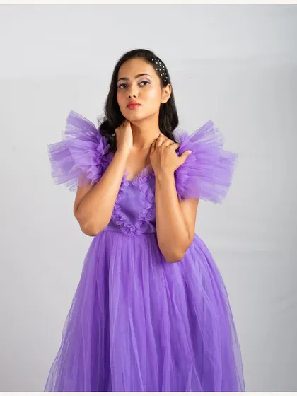 A beautiful lavender tulle gown with dramatic ruffled sleeves. This princess-style gown is perfect for making a grand entrance.