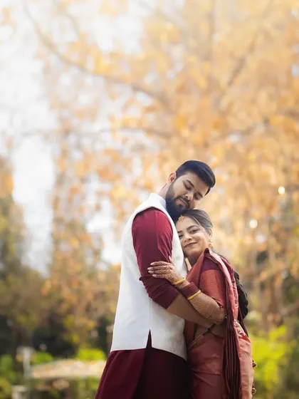 A warm embrace in a park with beautiful autumn colors. We can schedule your shoot to take advantage of seasonal foliage, adding a unique color palette to your photos.