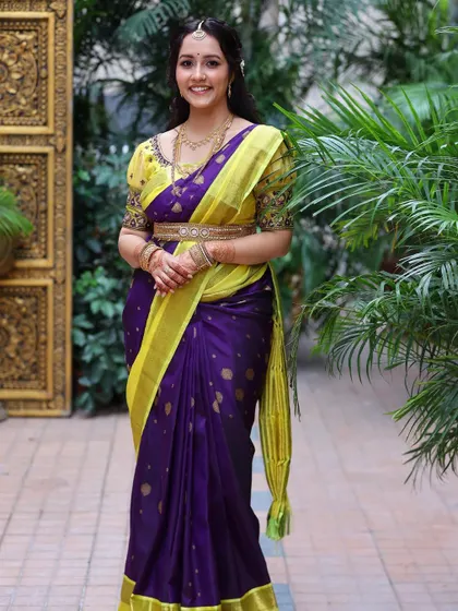Sheer elegance for Vaibhavi's engagement. Her beautiful purple and yellow saree is complemented by soft, glowing makeup and a simple hairstyle.