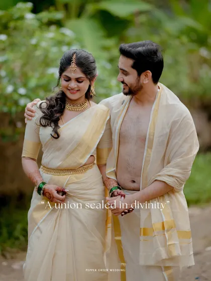 A romantic walking portrait of the couple, their traditional kasavu attire glowing in the soft light.