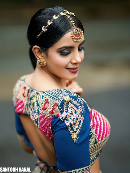A beautiful shot showcasing the intricate embroidery and design of the bride's blouse.
