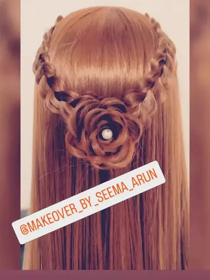 This open hairstyle combines a braided crown with a central rose detail. It's a very feminine and intricate style that looks stunning in photos, especially for outdoor settings.