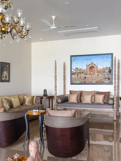 The living room of The Brick House is an eclectic mix of the client's existing furniture and art. A traditional Indian swing (jhoola) sits alongside contemporary sofas, showcasing our ability to design spaces that honor a client's personal history.