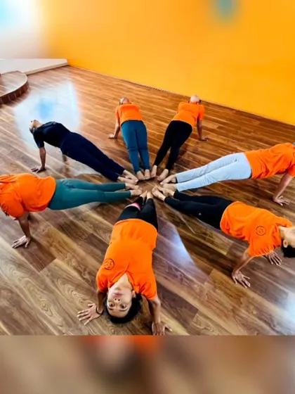 More fun with group yoga formations! These images capture the playful spirit and strong bonds forged in our training programs. It's all about connection and support.