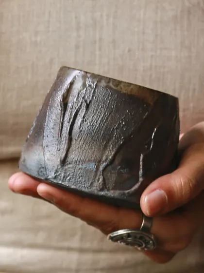 This saggar-fired piece, held in my hand, shows the smoky gradients and landscapes that can emerge from an electric kiln. It was a journey of learning and experimentation that reshaped the boundaries of my practice.