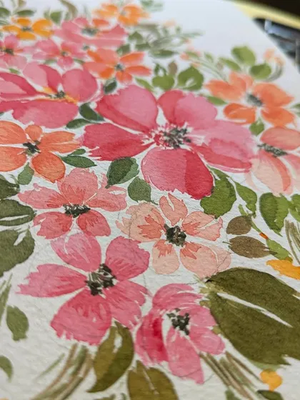 A close-up view of a loose floral watercolor piece. You can see the layers of color and the way the water blends the pigments to create soft, natural-looking petals. Each brushstroke is part of the story.