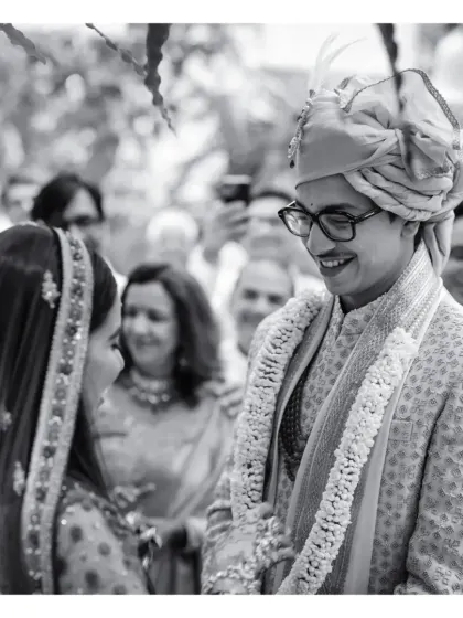 A beautiful black and white close-up of the groom's smiling face as he looks at his bride during the ceremony.