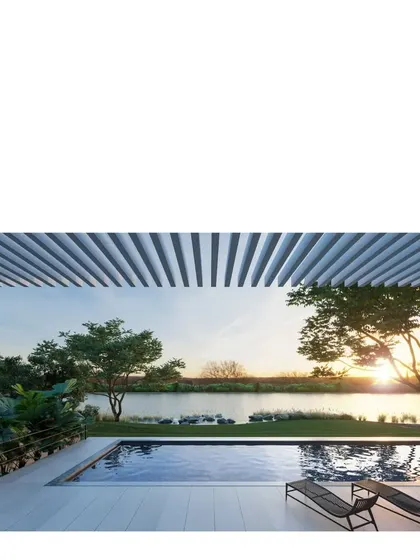 A view from the Koba House, where the living space opens onto a serene pool and a view of the Sabarmati river at sunset. The architecture is designed to frame and celebrate these moments.