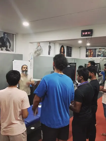 Another angle from the screening masterclass, showing the group's engagement as they learn how to conduct a thorough physical assessment.
