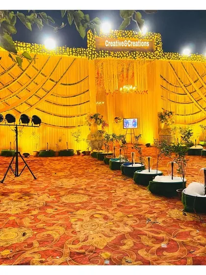 The grand yellow-themed venue at night, with all the lights creating a spectacular and inviting scene.