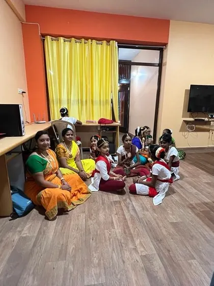A candid moment of rest and camaraderie between students and a guru during a break.