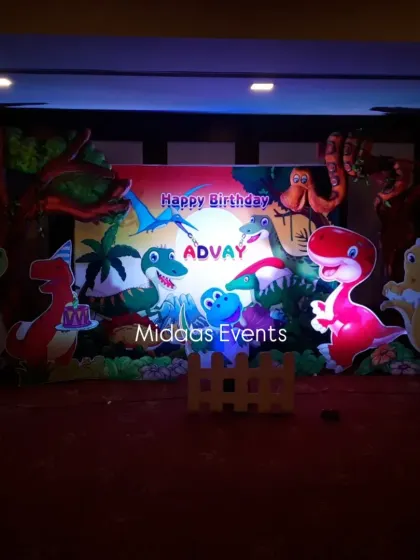 The dinosaur backdrop illuminated with spotlights. The lighting adds drama and highlights the vibrant colors of the theme, making it look great in photos and videos.