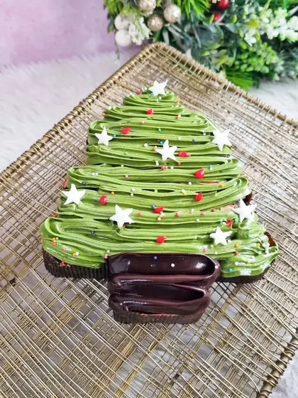 This brownie Christmas tree is a chocolate lover's dream. A rich brownie is frosted with green icing and decorated with star sprinkles for a festive touch.