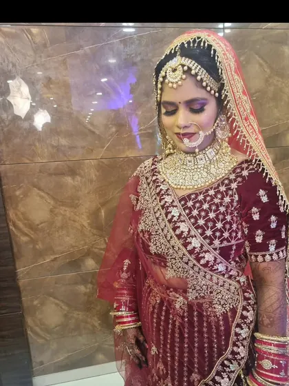 A beautiful shot of the bride with her eyes closed, showcasing the detailed eye makeup and the placement of her matha patti.