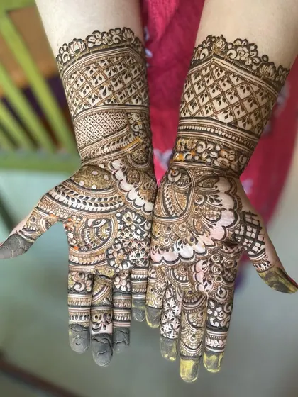 A beautiful, heavy design with intricate bands on the wrist and detailed work on the palms. The mix of dark and light shading adds a lot of depth.
