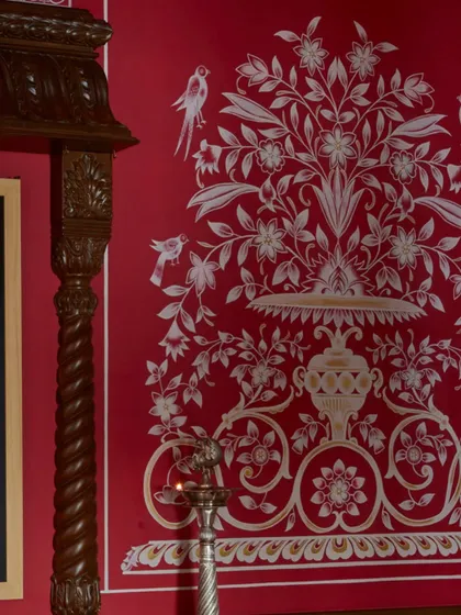 A close-up of the hand-painted motifs in the Hyderabad temple. The delicate birds and floral patterns, rendered with the subtle imperfections of the human hand, are what make the space feel so soulful. This is where bold design meets the quiet finesse of traditional craft.