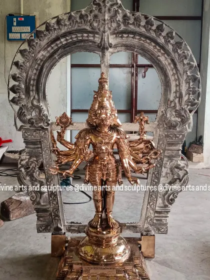 A work-in-progress photograph of a Panchamukhi Hanuman sculpture. The central figure is being polished to a golden shine, while the surrounding Prabhavali arch still has its raw, post-casting texture, showing the transformation.