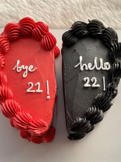 A clever "Bye 21, Hello 22" cake, made of two halves of a heart coming together.