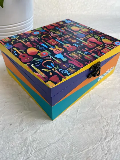 A side view of the custom music-themed box, showing the colorful, hand-painted stripes that match the vibrant design on the lid.