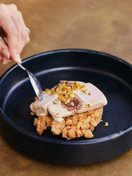 A spoonful of our Salted Chikki Kulfi, showing the perfect balance of creamy kulfi and crunchy chikki.