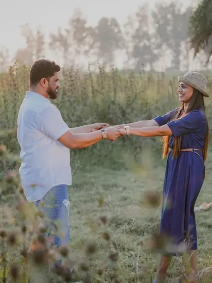 A playful moment from a countryside pre-wedding shoot, full of movement and happiness.