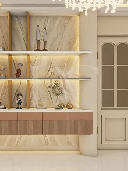 A close-up of the bespoke display unit. It features a marble-look back panel, backlit shelves to highlight decor pieces, and a floating console for storage, all framed by elegant, classic-style doors.