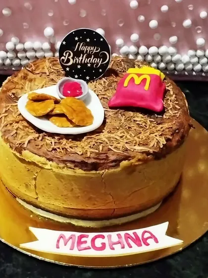 Concept cakes are so much fun to make. This one was for a McDonald's fan, complete with fondant nuggets and fries on a rich cheesecake. It's all about celebrating what makes someone happy.