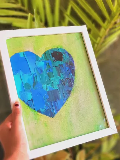 Holding this piece, you can see how the white frame makes the cool colors of the heart pop. The textured blues and greens against the soft lime background feel like a calm island in a gentle sea.
