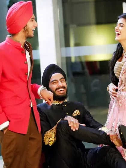 A candid moment of laughter between the bride, groom, and a friend. These are the real, unscripted memories that make a wedding album special.