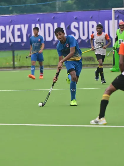 A player controlling the ball during a competitive match.