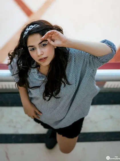 A creative high-angle shot taken outdoors. This perspective offers a unique and modern take on a casual portrait.