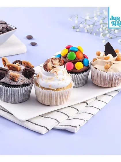 Another one of our delicious cupcake assortments. This box features a variety of toppings like M&Ms, Oreo cookies, and Snickers, making it a fun and tasty treat for any occasion.