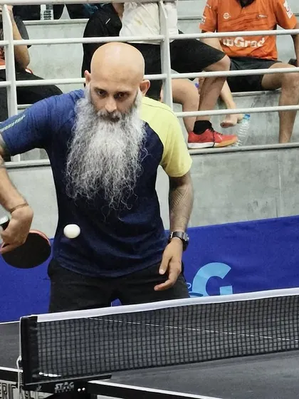 The intensity of a serve, captured mid-motion. This player's focus demonstrates the discipline instilled in our athletes, where every point begins with a well-executed serve.