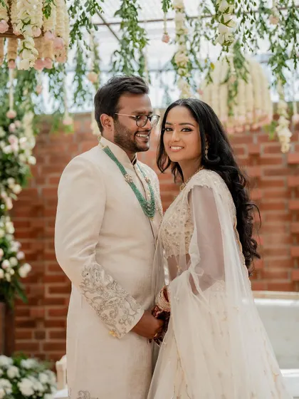 A stunning bride in a white lehenga, exuding grace and elegance. We use creative framing and lighting to capture a variety of beautiful portraits.