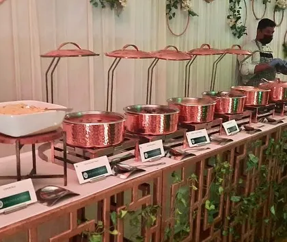 A professional buffet setup for a Diwali party, featuring a custom-designed counter and elegant copper serving dishes. My team ensures a seamless and high-quality service experience.