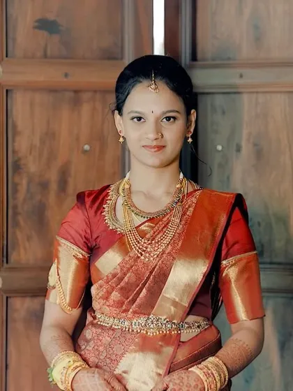 A classic portrait in a traditional red saree for her engagement.