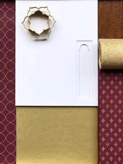 An early mood board for the banquet hall, showing the rich color palette of maroon and gold, traditional motifs, and fabric textures that guided the final design.