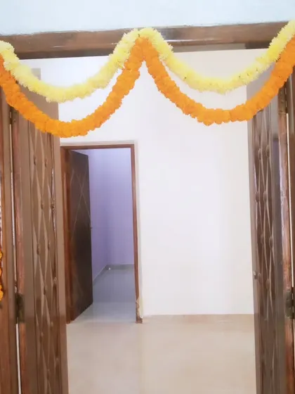 A very simple door or railing decoration using two marigold garlands.