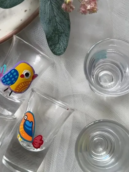 An overhead view of our colorful bird themed shot glasses. They are perfect for adding a playful touch to your barware collection.