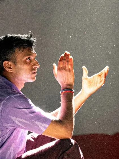 A candid moment during rehearsals. The light catches the dust in the air, symbolizing the hard work and dedication that goes into every practice session.
