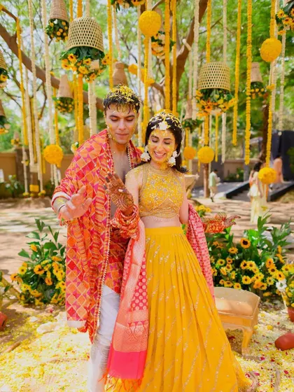 The happy couple at their haldi, perfectly complementing the fusion of contemporary aesthetics and traditional elements in the decor.