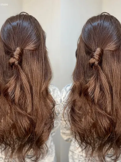 A cute half twist style on this lovely brown hair, showing its texture and shine.