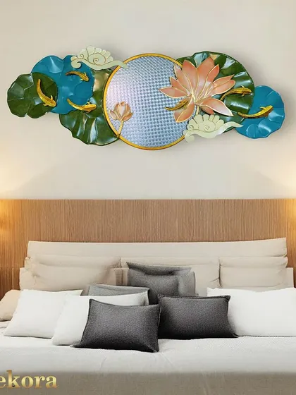 This serene wall sculpture features a lotus flower and swimming fish, centered around a textured disc. It's a beautiful piece for creating a calm, zen-like atmosphere in a bedroom.